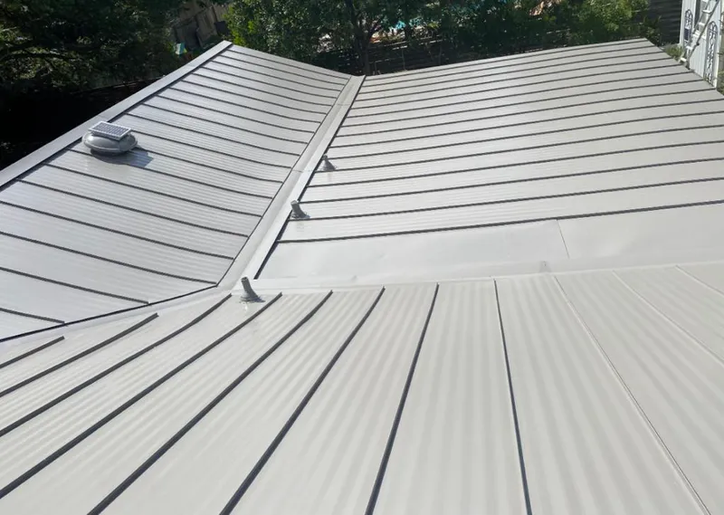 Solar attic fan installed on a metal roof for Roof Ventilation in Chicago Heights